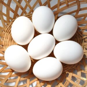 White eggs in a basket.