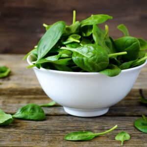 Spinach in a white glass bowl.