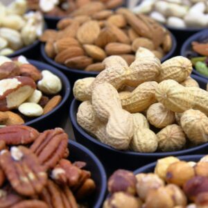Variety of nuts in multiple small bowls. 