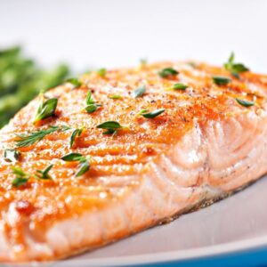 Cooked salmon with herbs.