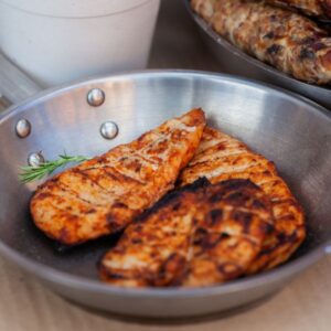 Cooked chicken breast in a silver bowl.